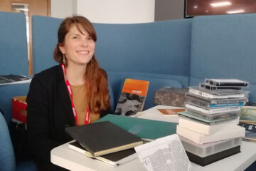 Dr Chiara Carolina Donelli at a desk with documents from the CSEAR library
