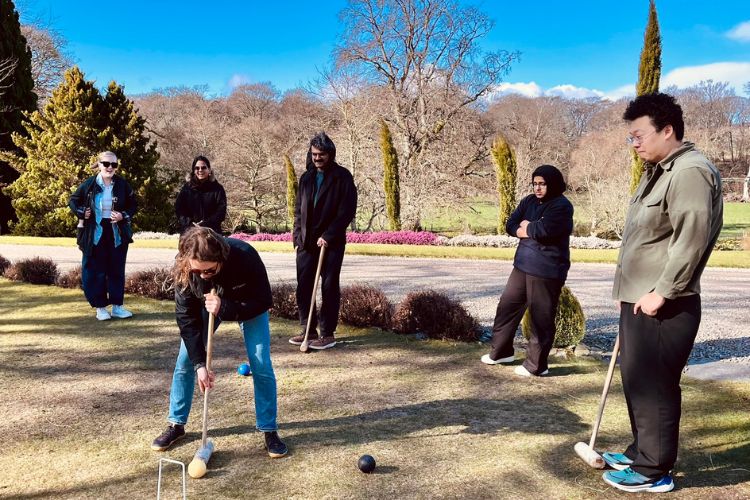 Business School PGR students playing croquet on the lawn at The Burn during the School's annual postgraduate research retreat.